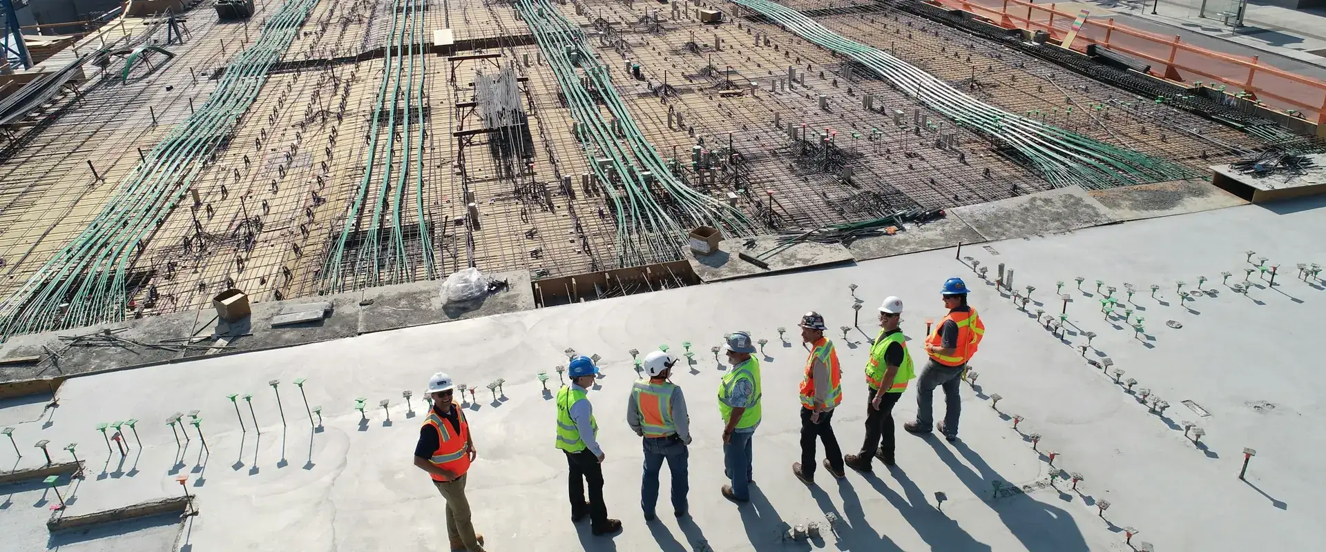 Engineers reviewing a hospital construction site with foundations and services