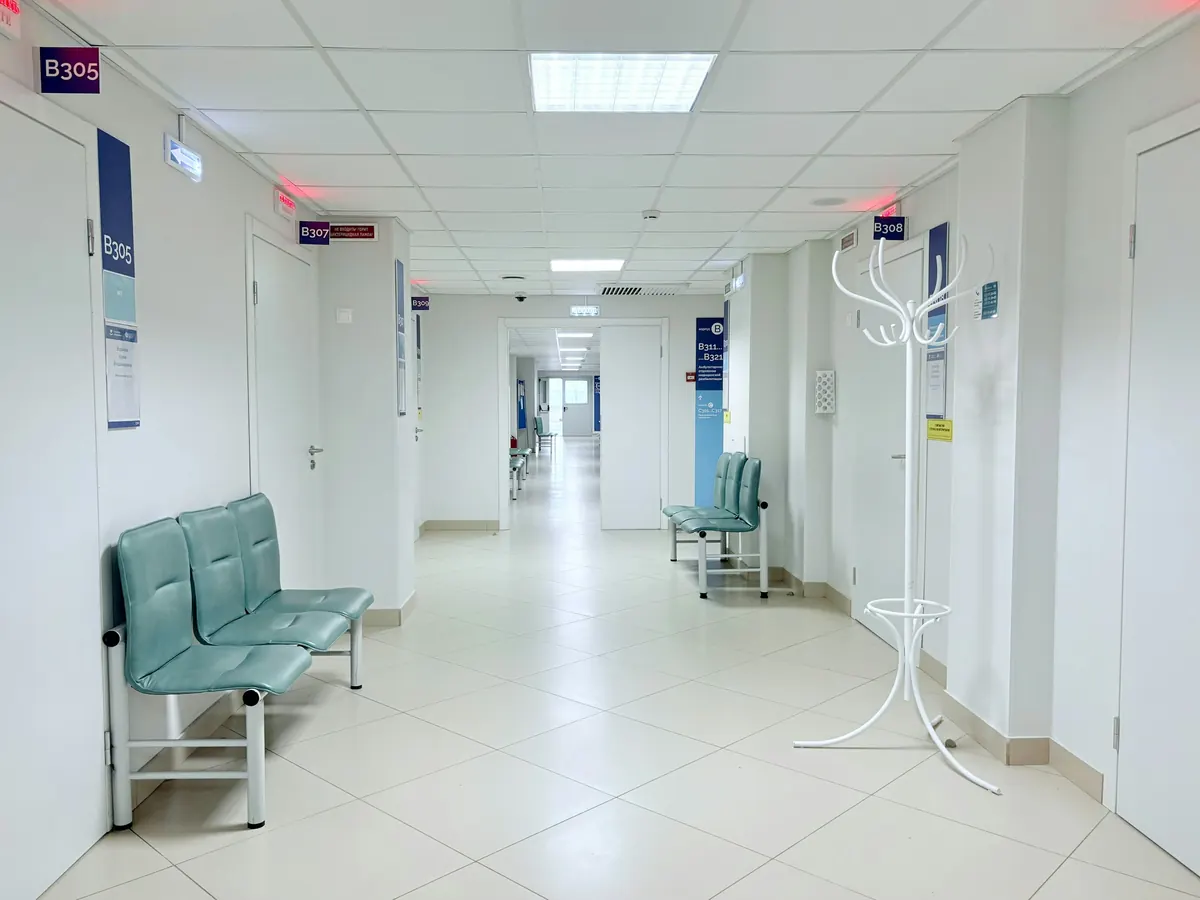 Clean hospital corridor with waiting seats and wide doors