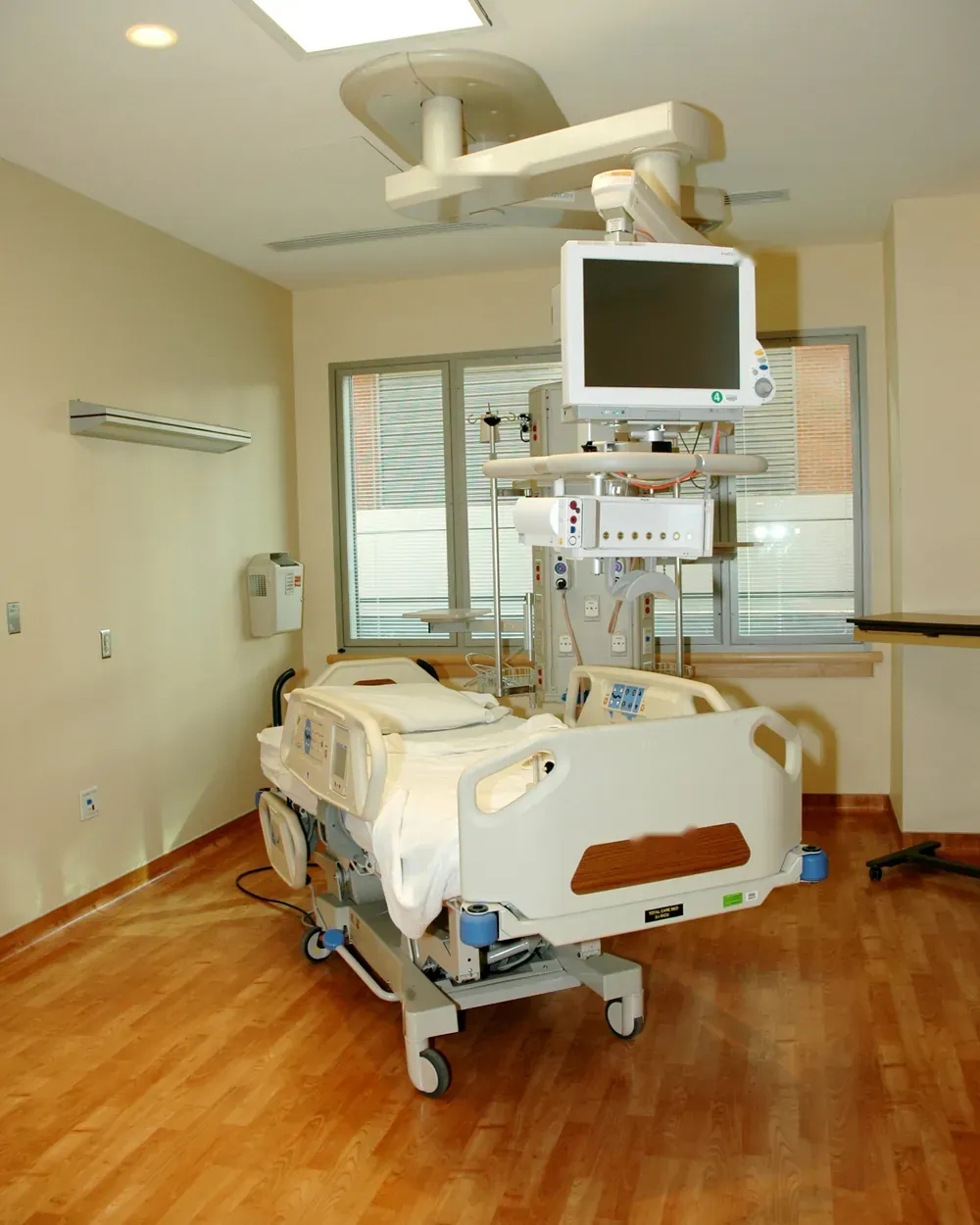 ICU room with hospital bed, monitor and wall services